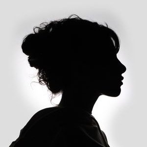 Striking black and white silhouette of a woman in profile, showcasing graceful features.
